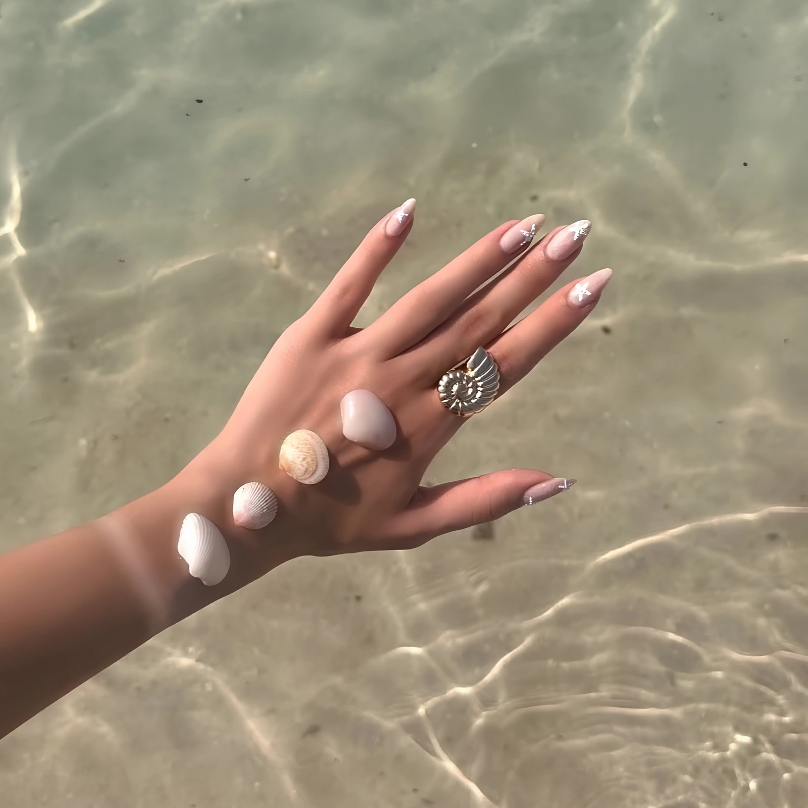 A manicured hand resting in soft sunlight